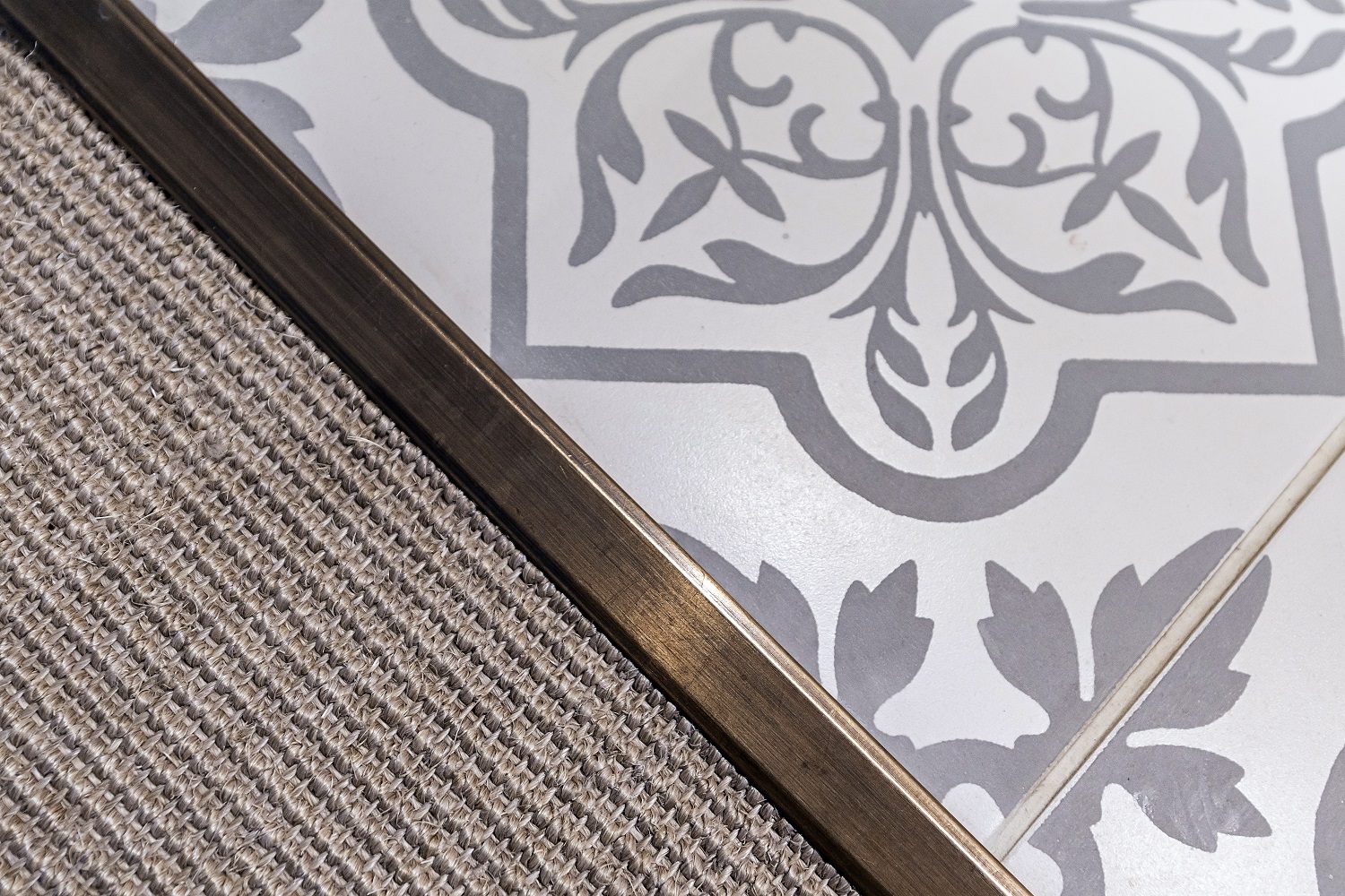 Close up of textures of rug on patterned tiles